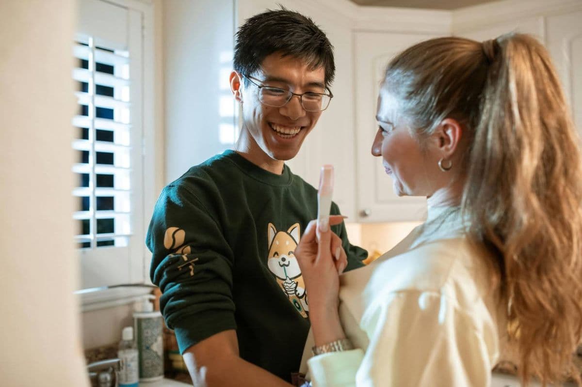 A couple looking at a positive pregnancy test together