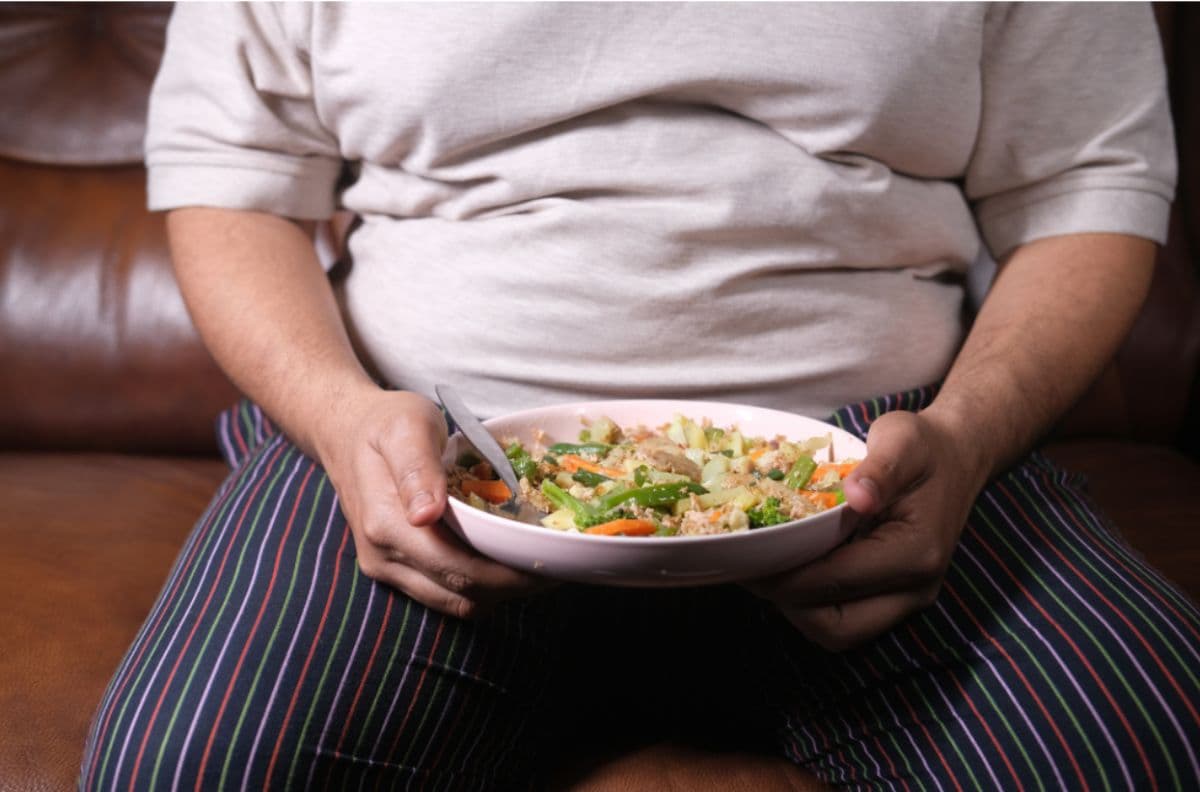 obese man with a plate of food